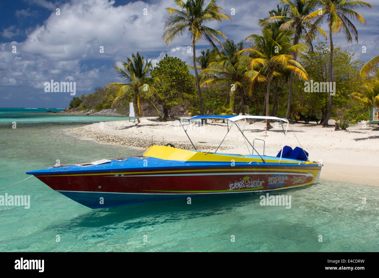 Bright Colored Caribbean Tour Boat Moored at Petit Bateau, Tobago Cays Marine Park. Stock Photo