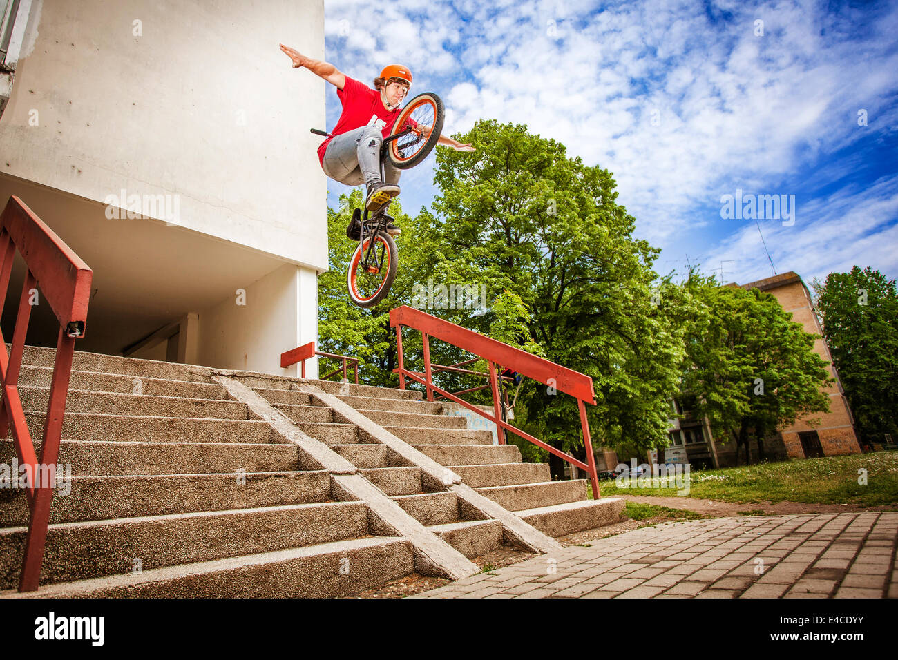 BMX biker performing a stunt over a staircase Stock Photo