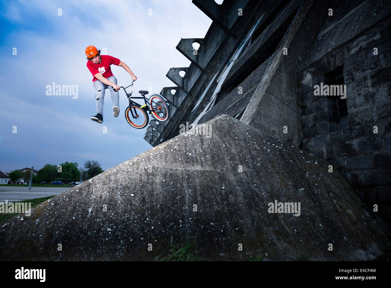 BMX biker performing a stunt on a bridge Stock Photo