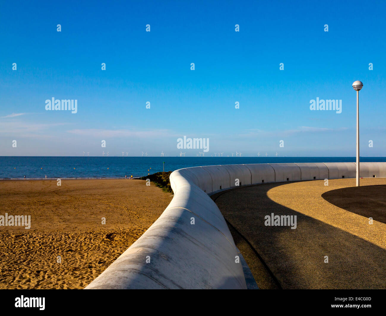 The sandy beach and promenade at Colwyn Bay in Conwy North Wales UK with a curved concrete wall in the foreground Stock Photo