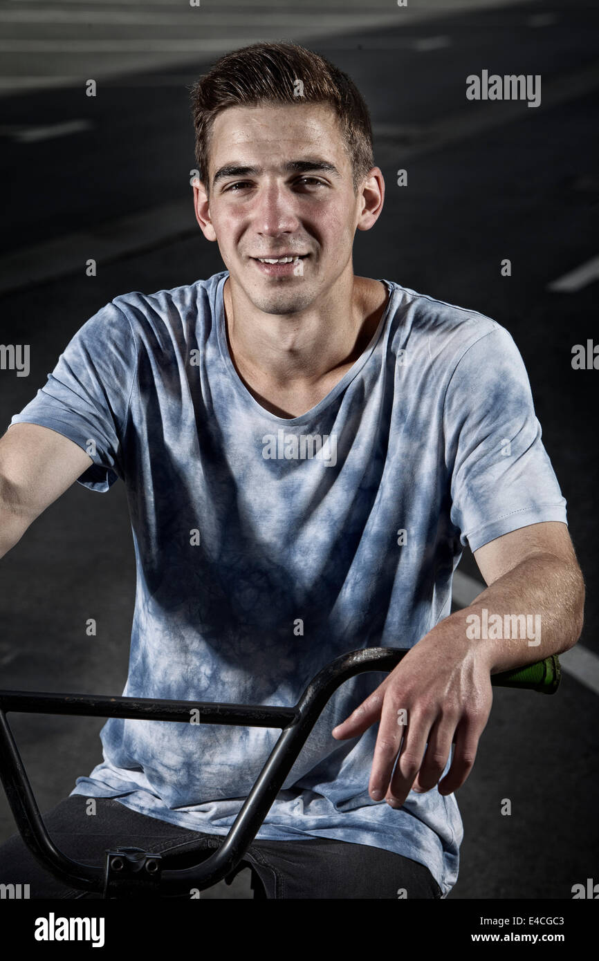Young man with BMX bike looking at camera Stock Photo