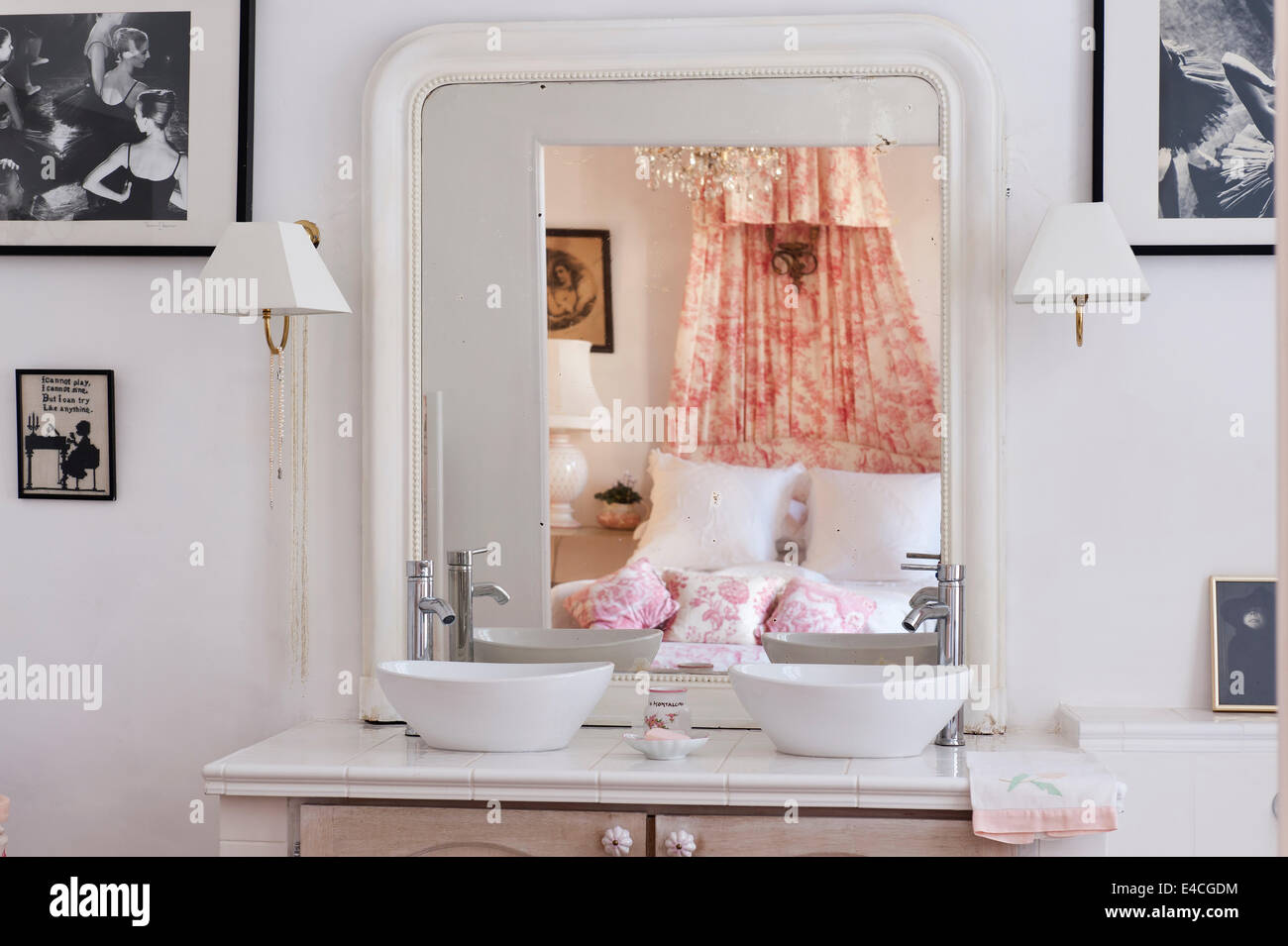 Double vanity unit with bed reflected in mirror Stock Photo