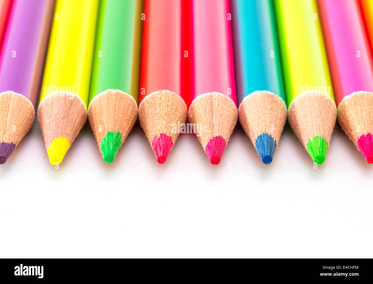 Bright color pencils on a white paper background Stock Photo