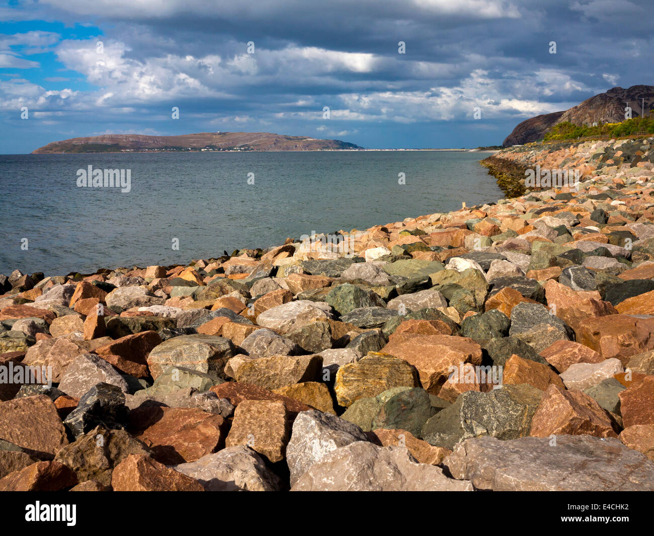 Sea defences on the North Wales coastline at Penmaenmawr in Conwy with large rocks and boulders used to prevent coastal erosion Stock Photo
