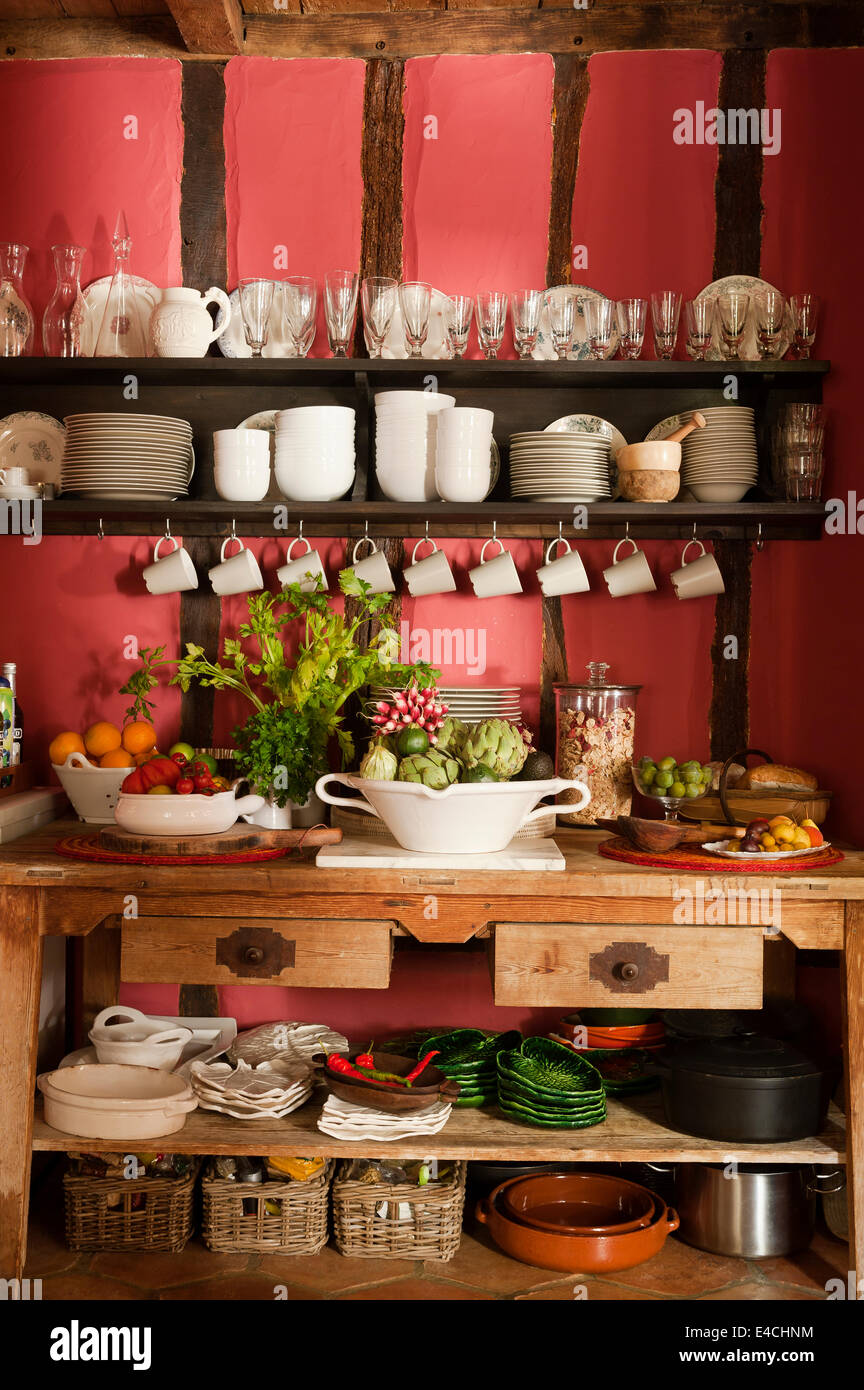 Open shelving in rustic French country kitchen with timber framed walls