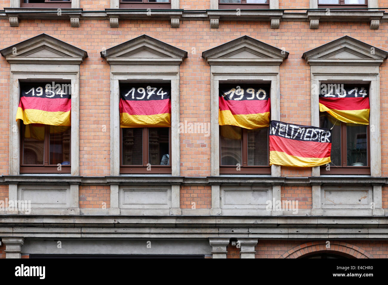 Germany Football World Champion 1954 1974 1990 and 2014; Flags with the year dates at the windows of an German fan Stock Photo