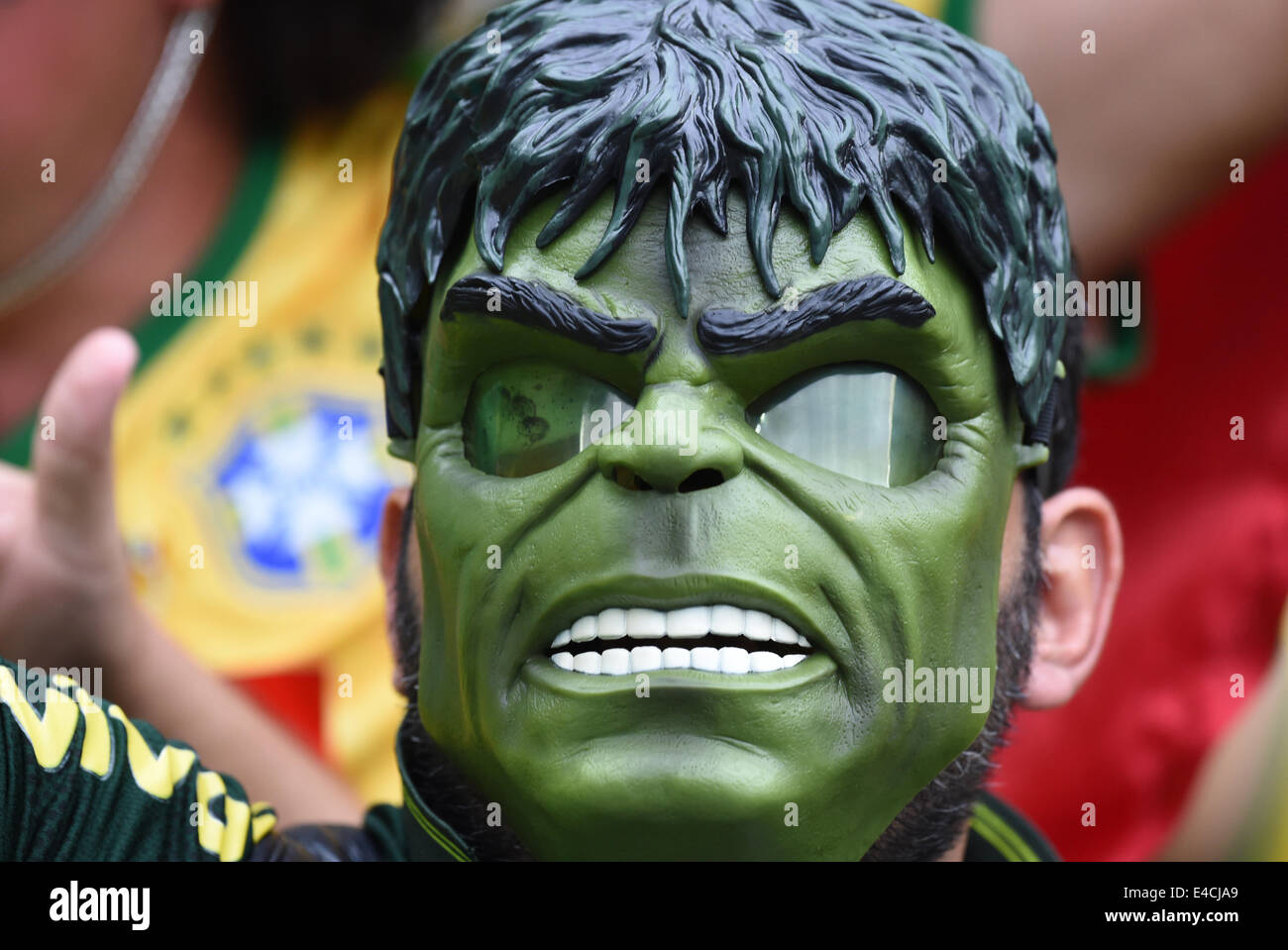Belo Horizonte, Brazil. 08th July, 2014. A supporter of Brazil poses with face mask of Hulk prior to the FIFA World Cup 2014 semi-final soccer match between Brazil and Germany at Estadio Mineirao in Belo Horizonte, Brazil, 08 July 2014. Photo: Marcus Brandt/dpa/Alamy Live News Stock Photo