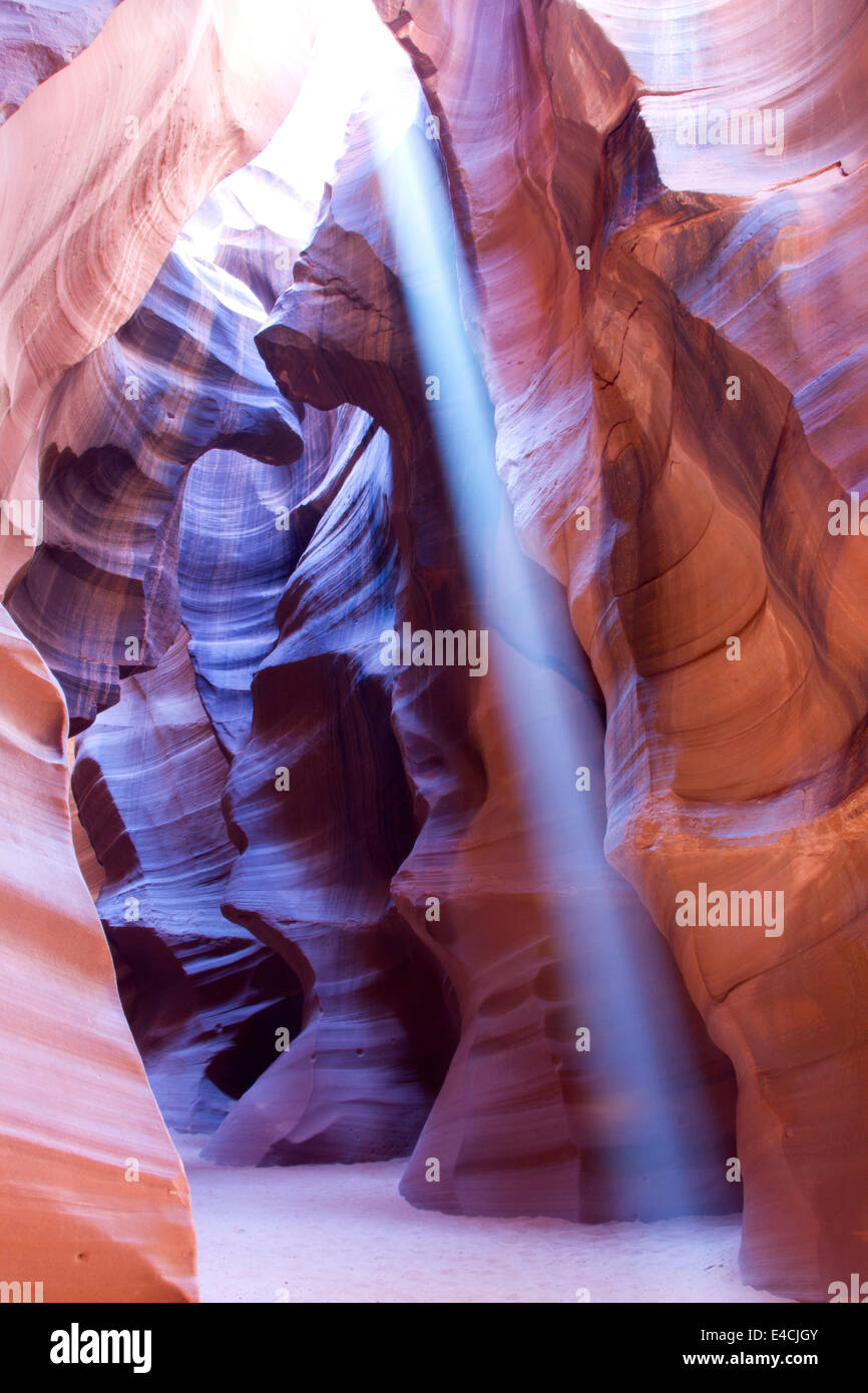 Light beam shining on slot canyon floor Stock Photo