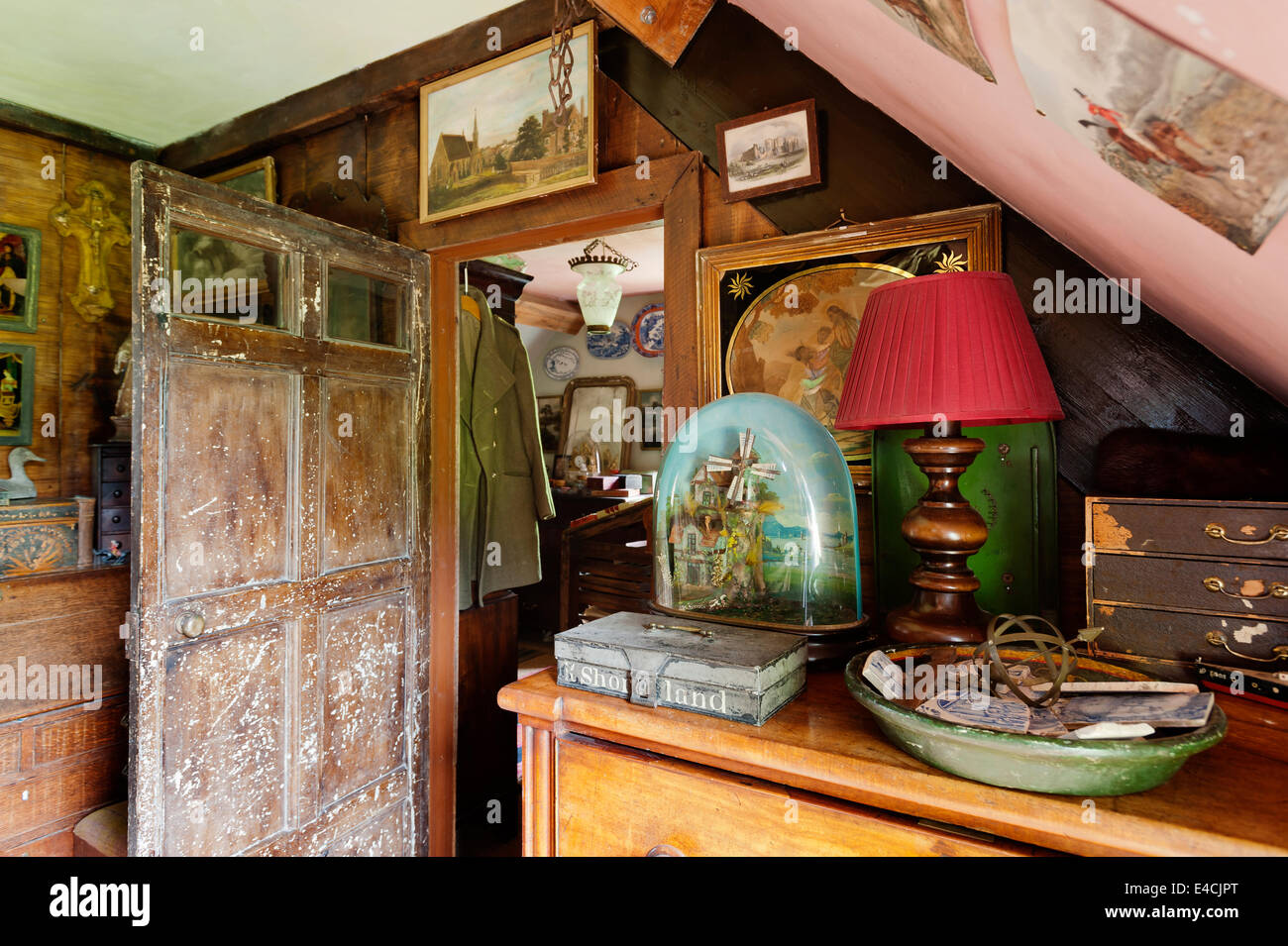 An Automaton musical windmill diorama on wooden chest in cluttered room with 17th century pine door Stock Photo