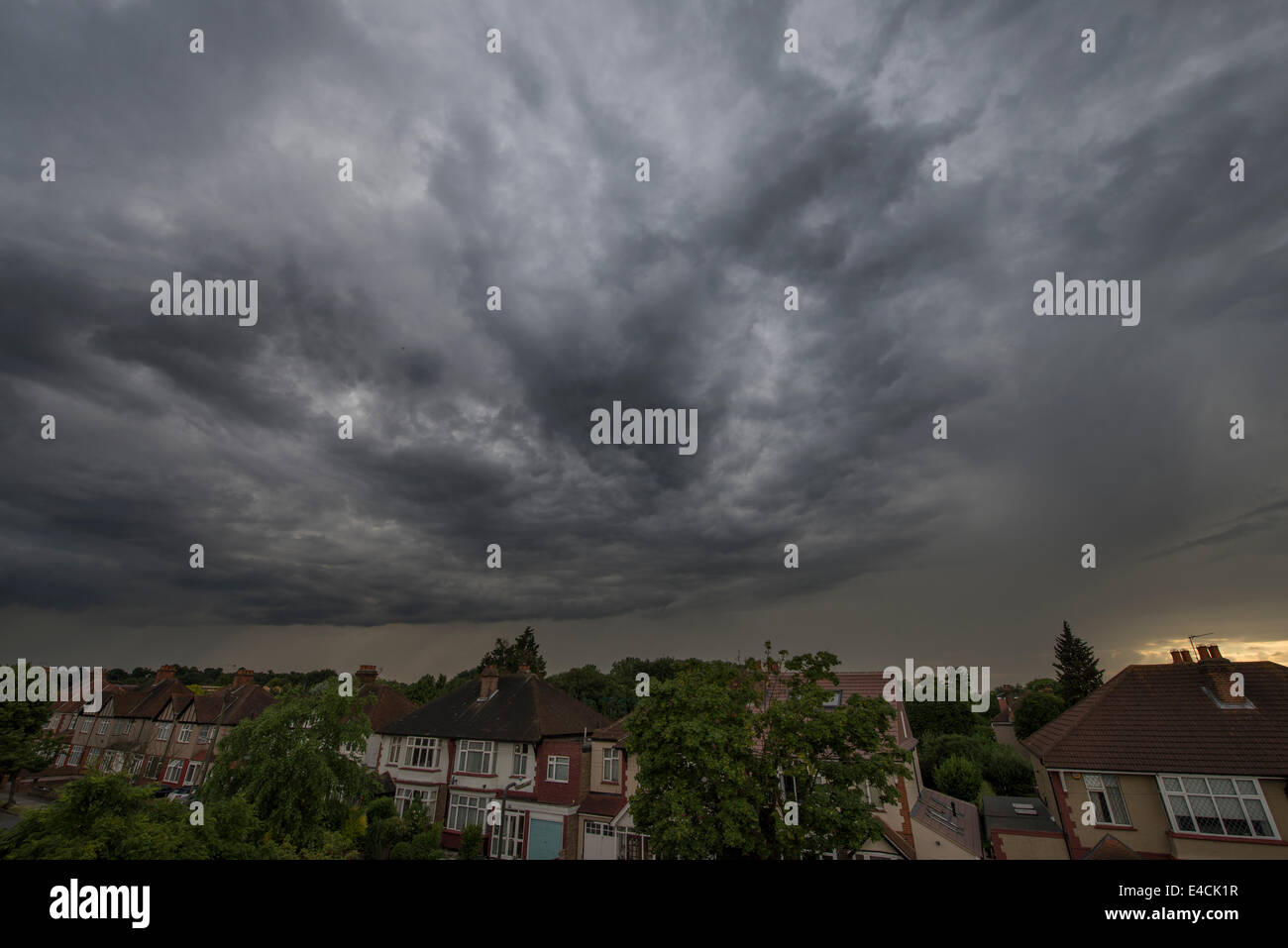 Wimbledon, London, UK. 8th July, 2014. A large mass of rain cloud passes over the south London suburb at dusk after an afternoon of lightning storms in parts of Surrey. Credit:  Malcolm Park editorial/Alamy Live News Stock Photo
