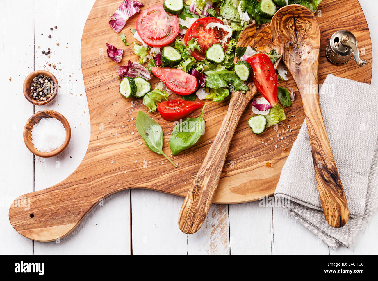 Ingredients of Fresh vegetable salad on olive wood cutting board Stock Photo