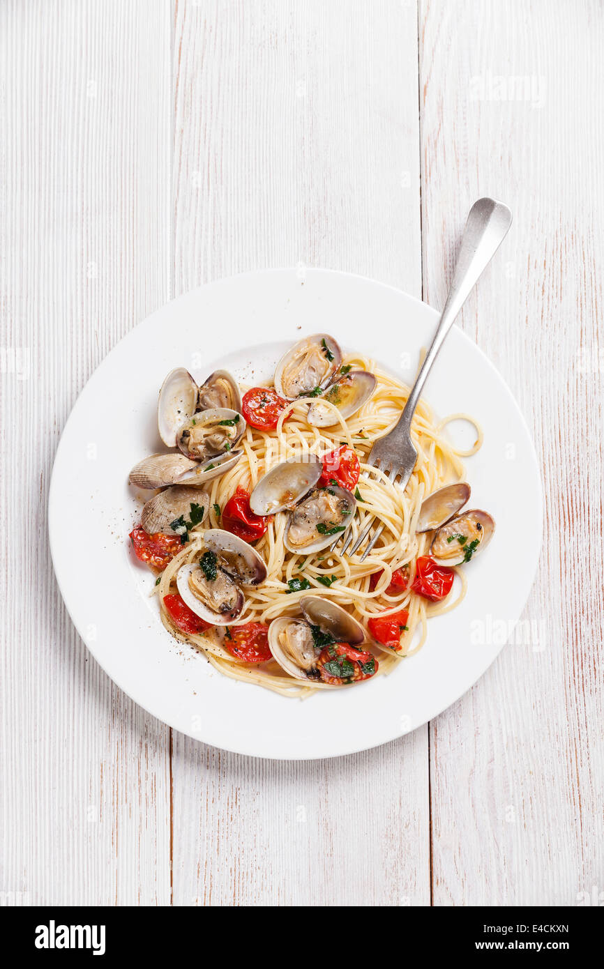 Seafood pasta with clams in tomato sauce Spaghetti Vongole on white