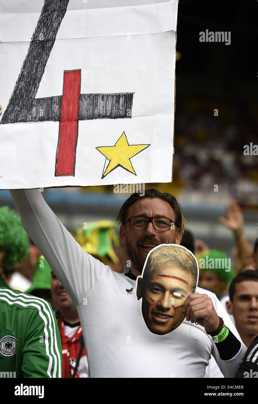 Belo Horizonte, Brazil. 8th July, 2014. A Germany's supporter holds a banner and a mask of Brazil's Neymar before a semifinal match between Brazil and Germany of 2014 FIFA World Cup at the Estadio Mineirao Stadium in Belo Horizonte, Brazil, on July 8, 2014. Credit:  Qi Heng/Xinhua/Alamy Live News Stock Photo