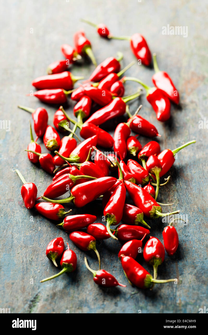 Red Hot Chili Peppers over wooden background Stock Photo