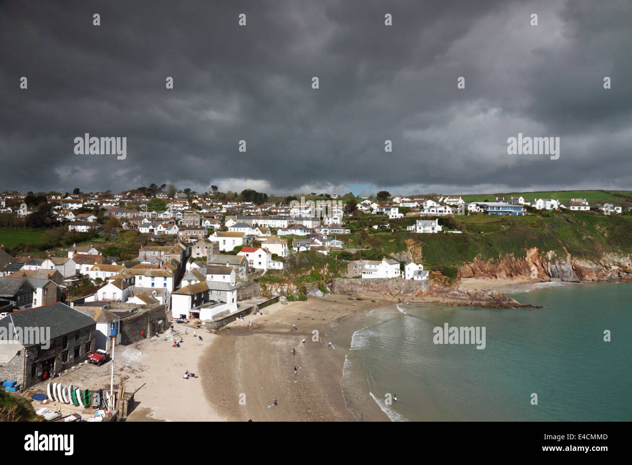 A seaside village with a sandy beach and black leaden sky. Stock Photo
