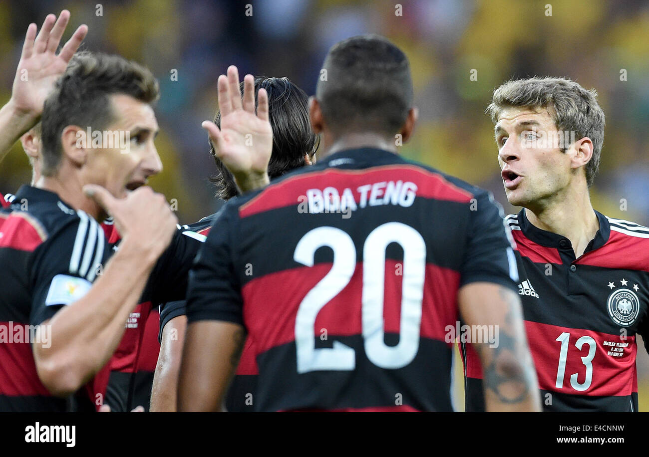Belo Horizonte, Brazil. 08th July, 2014. Miroslav Klose (L) of Germany celebrates with his teammmates Jerome Boateng and Thomas Mueller (R) after scoring 0-2 goal during the FIFA World Cup 2014 semi-final soccer match between Brazil and Germany at Estadio Mineirao in Belo Horizonte, Brazil, 08 July 2014. Photo: Marcus Brandt/dpa/Alamy Live News Stock Photo