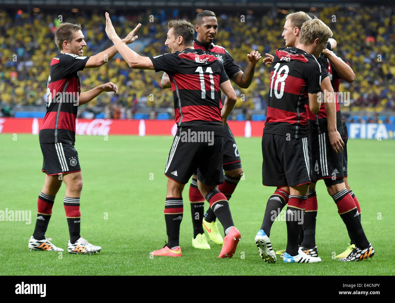 Belo Horizonte, Brazil. 08th July, 2014. Toni Kroos (2-R) of Germany celebrates with his teammmates Philipp Lahm (L) and Miroslav Klose (2-L) after scoring 0-3 goal during the FIFA World Cup 2014 semi-final soccer match between Brazil and Germany at Estadio Mineirao in Belo Horizonte, Brazil, 08 July 2014. Photo: Marcus Brandt/dpa/Alamy Live News Stock Photo