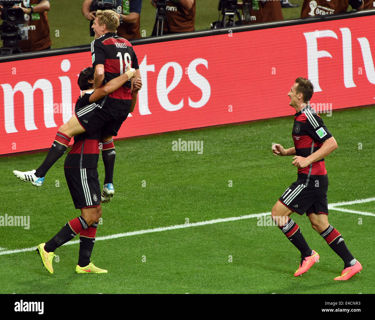 Belo Horizonte, Brazil. 08th July, 2014. Germany's Toni Kroos (C) celebrates with team mates Sami Khedira and Miroslav Klose (R) after scoring a goal during the FIFA World Cup 2014 semi-final soccer match between Brazil and Germany at Estadio Mineirao in Belo Horizonte, Brazil, 08 July 2014. Photo: Andreas Gebert/dpa/Alamy Live News Stock Photo