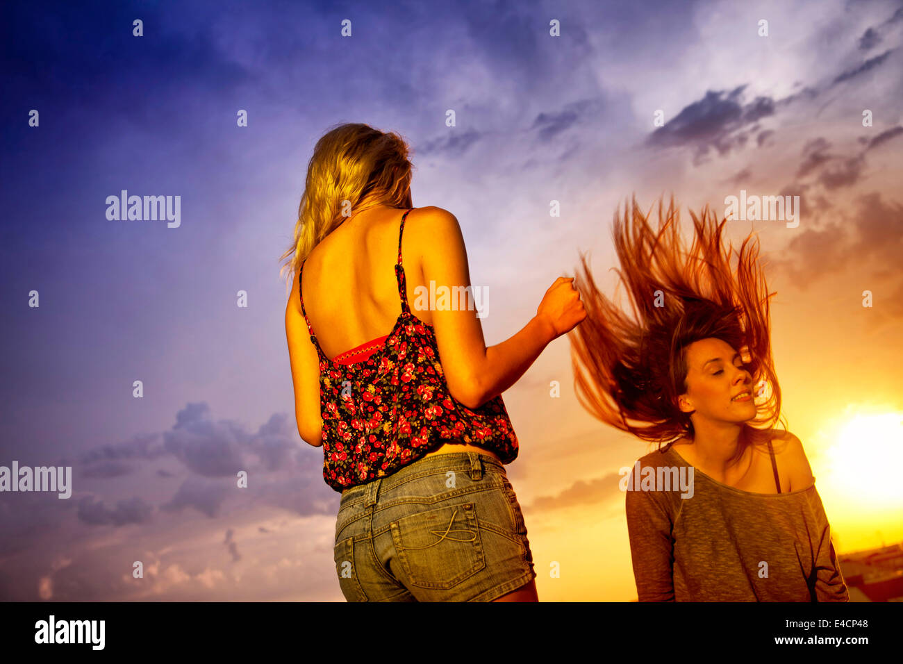 Two young women enjoying the sunset, Osijek, Croatia Stock Photo