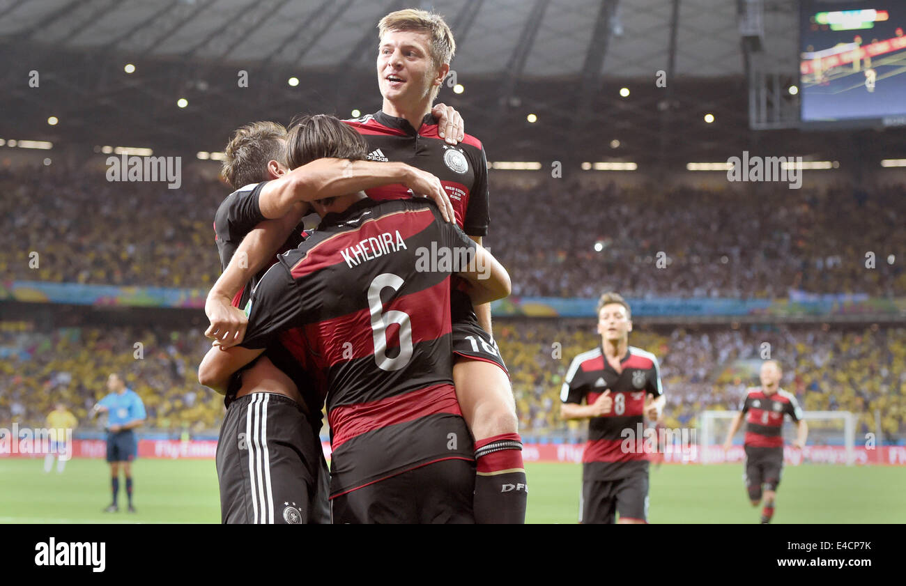 Belo Horizonte, Brazil. 08th July, 2014. Toni Kroos (top) of Germany celebrates with his teammate Miroslav Klose (L) and Sami Khedira (R) after the scoring a goal during the FIFA World Cup 2014 semi-final soccer match between Brazil and Germany at Estadio Mineirao in Belo Horizonte, Brazil, 08 July 2014. Photo: Marcus Brandt/dpa/Alamy Live News Stock Photo