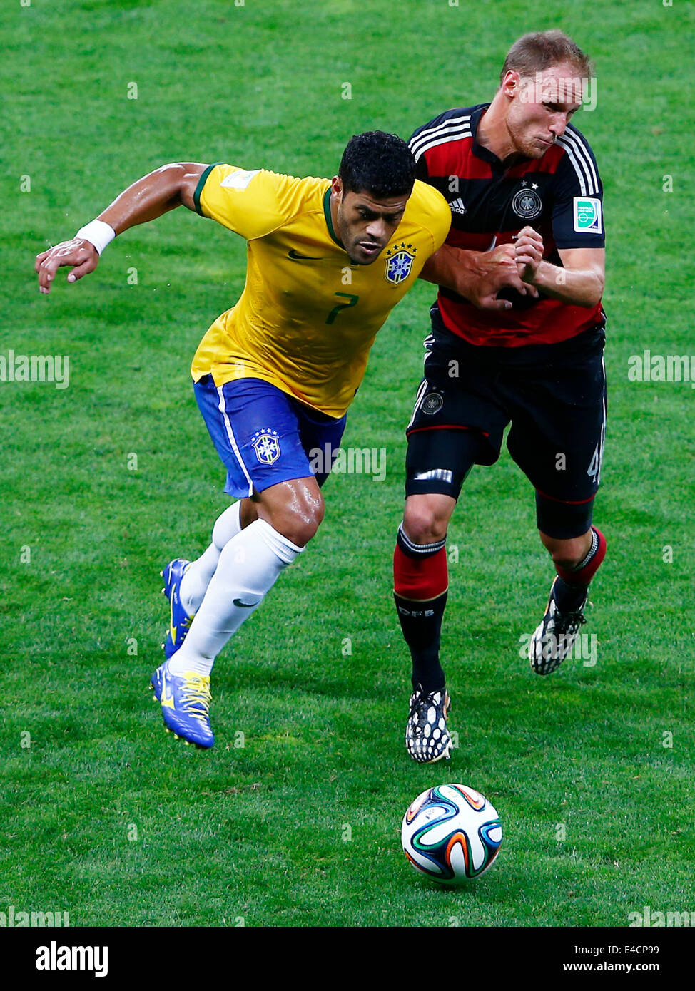 Belo Horizonte, Brazil. 8th July, 2014. Brazil's Hulk (L) vies with Germany's Benedikt Howedes during a semifinal match between Brazil and Germany of 2014 FIFA World Cup at the Estadio Mineirao Stadium in Belo Horizonte, Brazil, on July 8, 2014. Credit:  Liu Bin/Xinhua/Alamy Live News Stock Photo