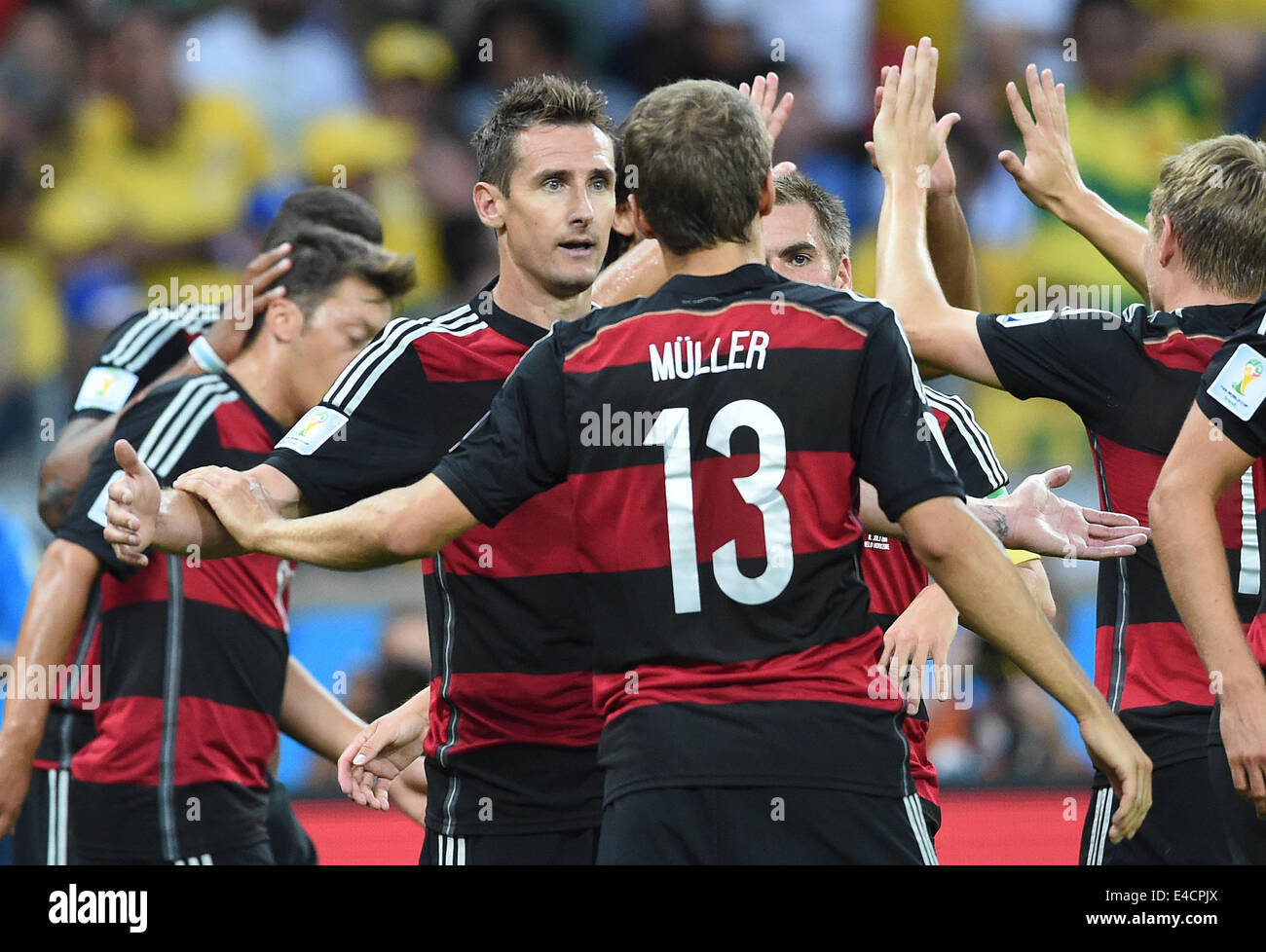 Belo Horizonte, Brazil. 08th July, 2014. Miroslav Klose (L) of Germany celebrates with his teammmates Thomas Mueller after scoring 0-2 goal during the FIFA World Cup 2014 semi-final soccer match between Brazil and Germany at Estadio Mineirao in Belo Horizonte, Brazil, 08 July 2014. Photo: Marcus Brandt/dpa/Alamy Live News Stock Photo