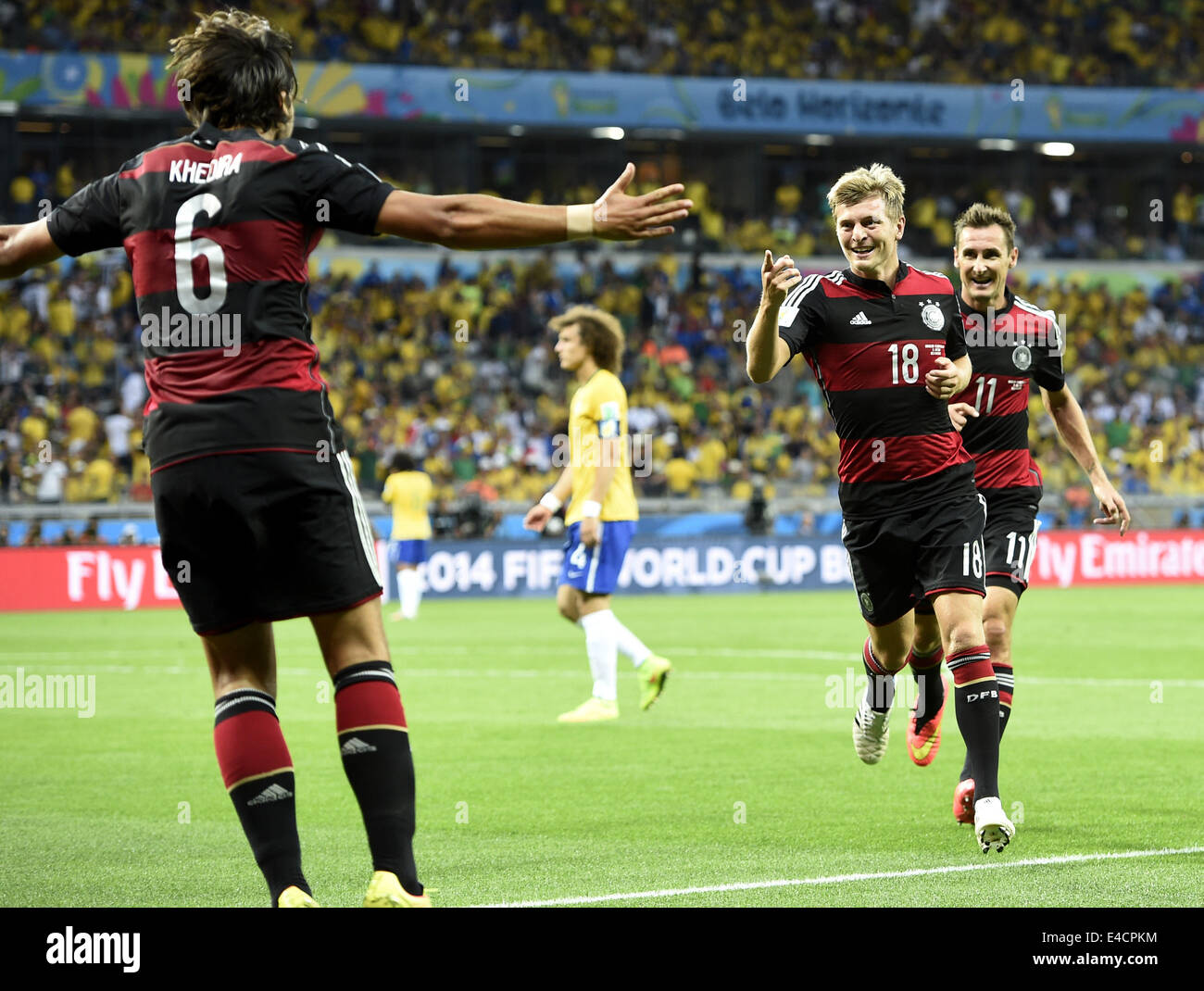 Belo Horizonte, Brazil. 8th July, 2014. Germany's Miroslav Klose (R) and Sami Khedira (L) celebrate with Toni Kroos (C) for Toni's second goal during a semifinal match between Brazil and Germany of 2014 FIFA World Cup at the Estadio Mineirao Stadium in Belo Horizonte, Brazil, on July 8, 2014. Credit:  Qi Heng/Xinhua/Alamy Live News Stock Photo