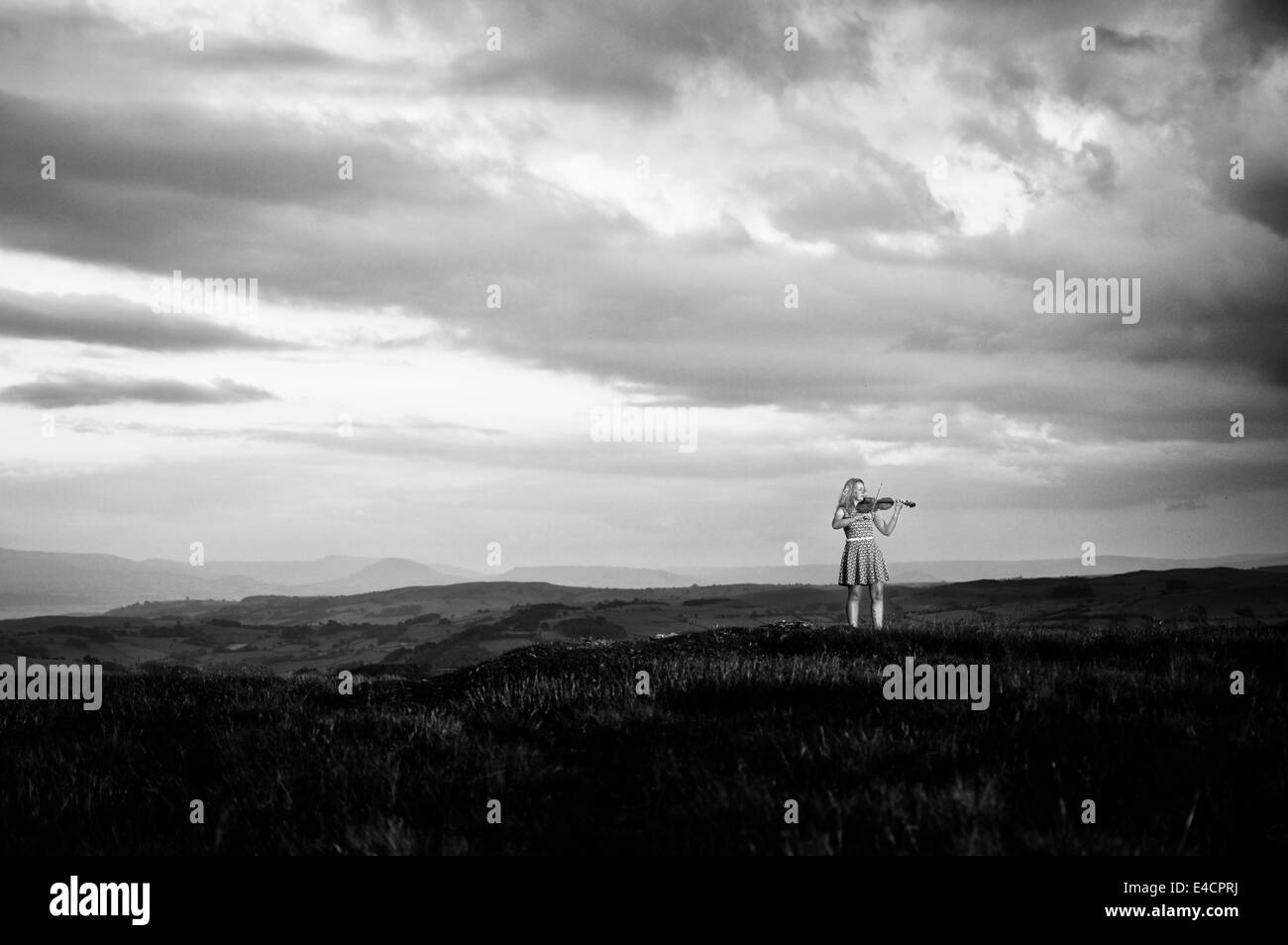 Women violinist playing in a moorland Stock Photo
