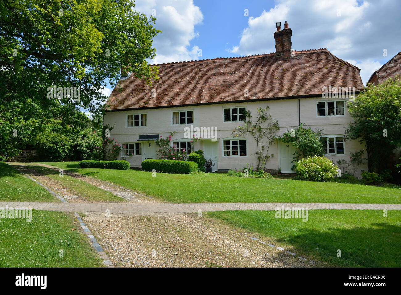Country cottage on the green in front of the village church in Selborne, Hampshire, England, UK Stock Photo