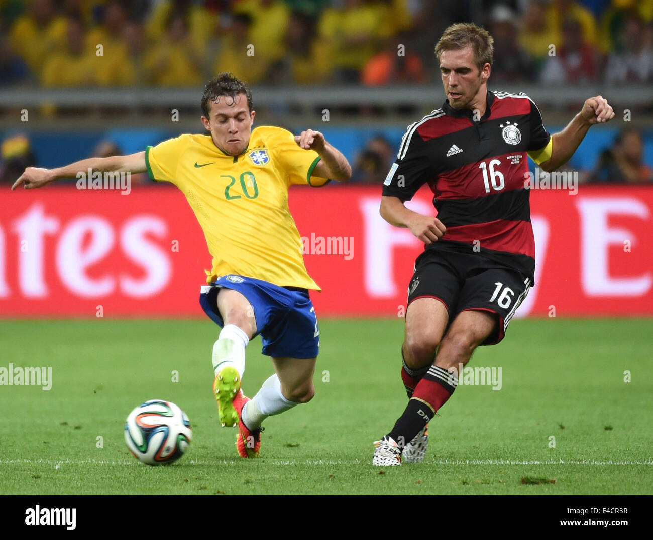Belo Horizonte, Brazil. 8th July, 2014. Brazil's Bernard vies with Germany's Philipp Lahm during a semifinal match between Brazil and Germany of 2014 FIFA World Cup at the Estadio Mineirao Stadium in Belo Horizonte, Brazil, on July 8, 2014. Credit:  Li Ga/Xinhua/Alamy Live News Stock Photo