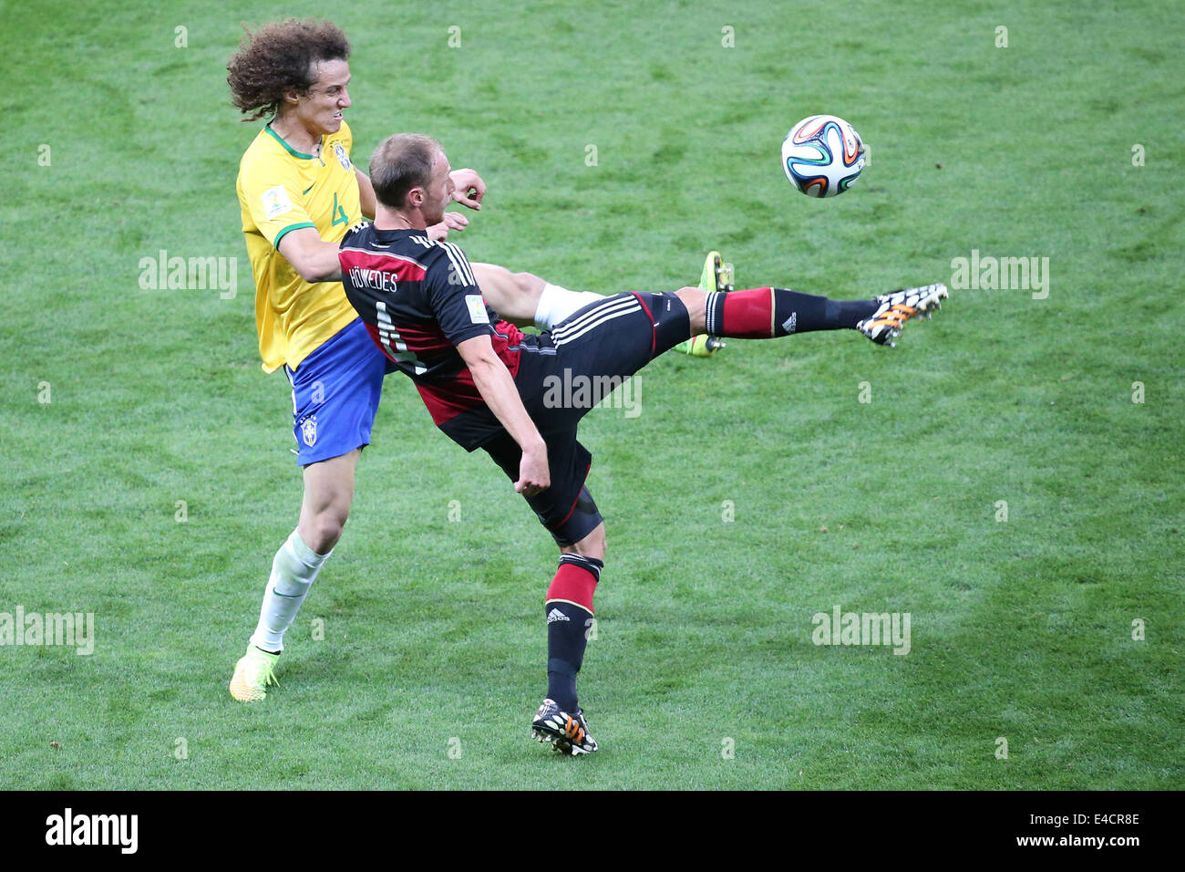 Belo Horizonte, Brazil. 8th July, 2014. Brazil's David Luiz vies with Germany's Benedikt Howedes during a semifinal match between Brazil and Germany of 2014 FIFA World Cup at the Estadio Mineirao Stadium in Belo Horizonte, Brazil, on July 8, 2014. Credit:  Li Ming/Xinhua/Alamy Live News Stock Photo