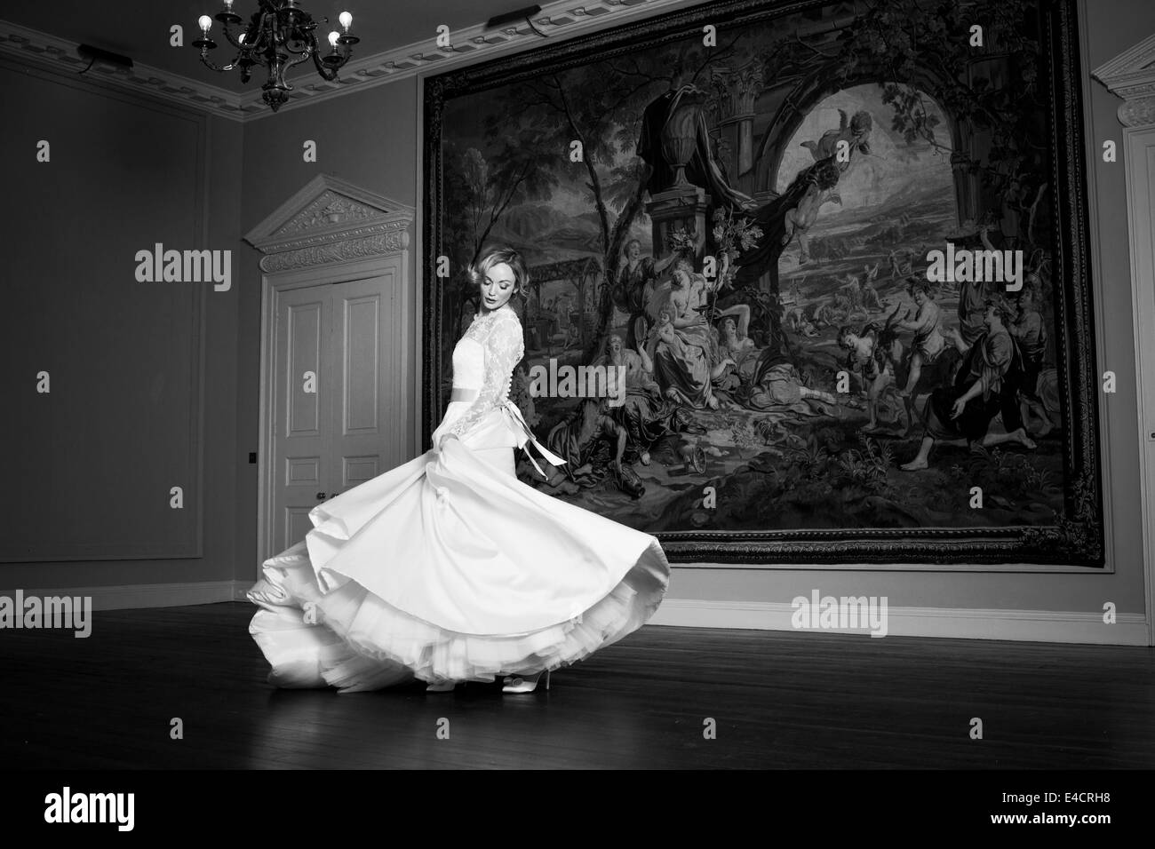 Wedding preparations, Bride dancing against old painting, Dorset, England Stock Photo