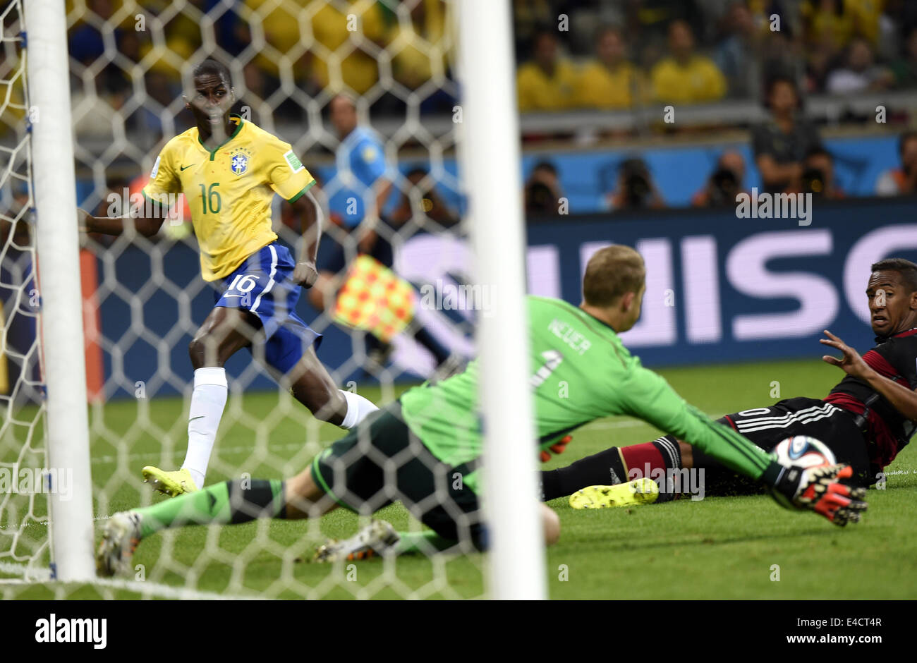 Belo Horizonte, Brazil. 8th July, 2014. Germany's goalkeeper Manuel Neuer (front) blocks the ball shot by Brazil's Ramires (L) during a semifinal match between Brazil and Germany of 2014 FIFA World Cup at the Estadio Mineirao Stadium in Belo Horizonte, Brazil, on July 8, 2014. Germany won 7-1 over Brazil and qualified for the final on Tuesday. Credit:  Qi Heng/Xinhua/Alamy Live News Stock Photo