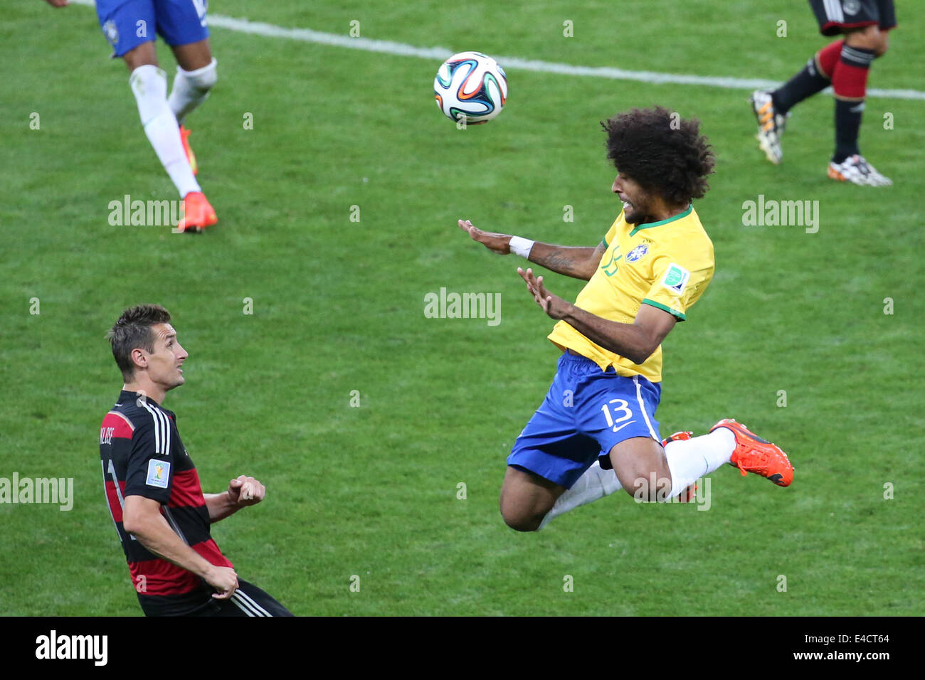 Belo Horizonte, Brazil. 8th July, 2014. Brazil's Dante vies with Germany's Miroslav Klose during a semifinal match between Brazil and Germany of 2014 FIFA World Cup at the Estadio Mineirao Stadium in Belo Horizonte, Brazil, on July 8, 2014. Credit:  Li Ming/Xinhua/Alamy Live News Stock Photo