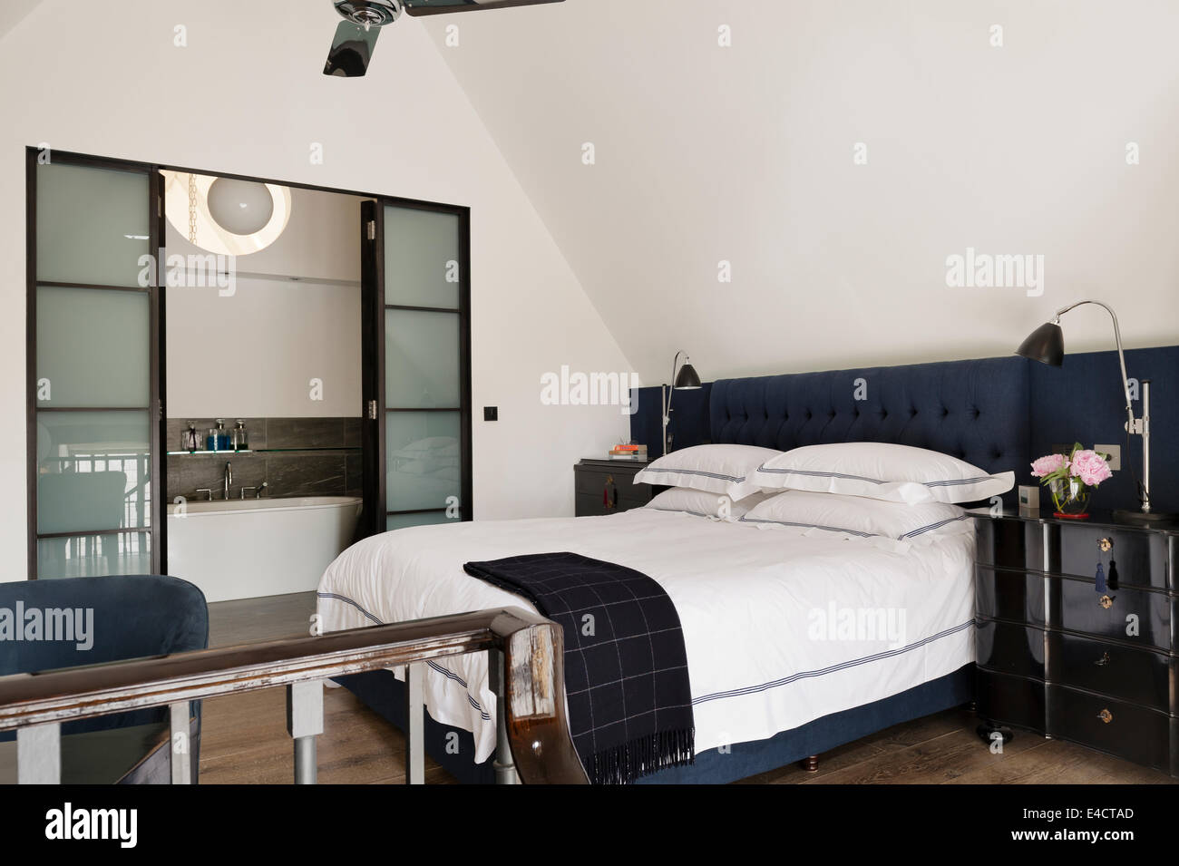 Dark Blue Buttoned Headboard On Bed In Bedroom With Ensuite