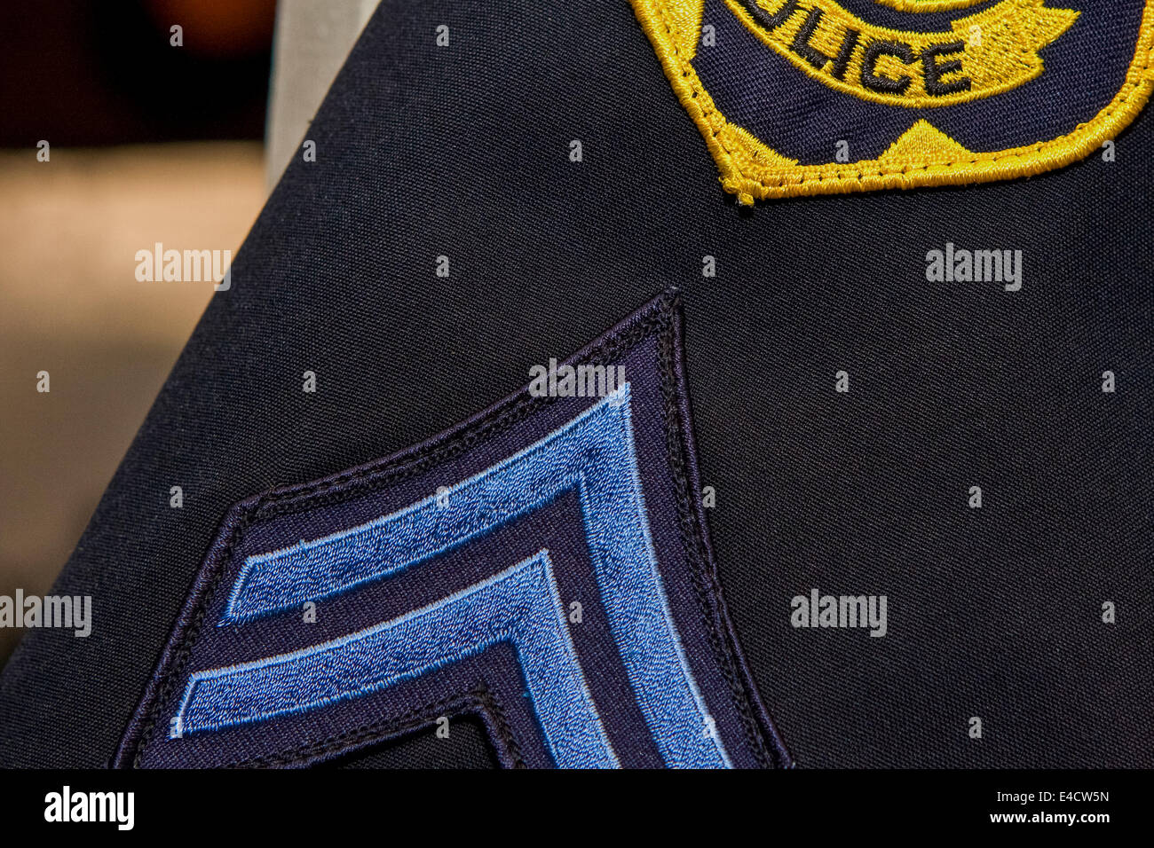 Close up of Police Patch and Corporal Stripes on a Blue Uniform Shirt
