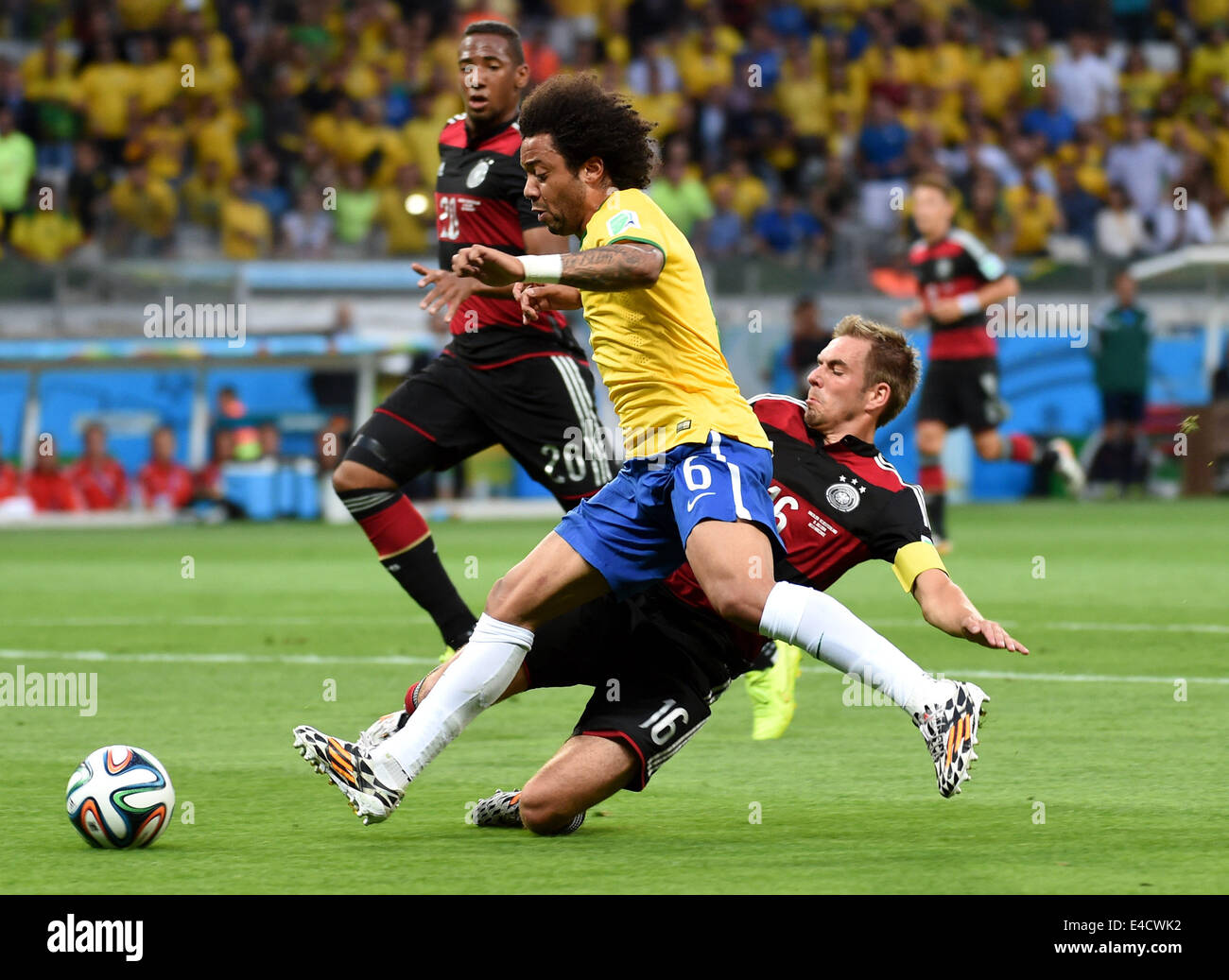 Belo Horizonte, Brazil. 8th July, 2014. Brazil's Marcelo vies with Germany's Philipp Lahm during a semifinal match between Brazil and Germany of 2014 FIFA World Cup at the Estadio Mineirao Stadium in Belo Horizonte, Brazil, on July 8, 2014. Germany won 7-1 over Brazil and qualified for the final on Tuesday. Credit:  Li Ga/Xinhua/Alamy Live News Stock Photo