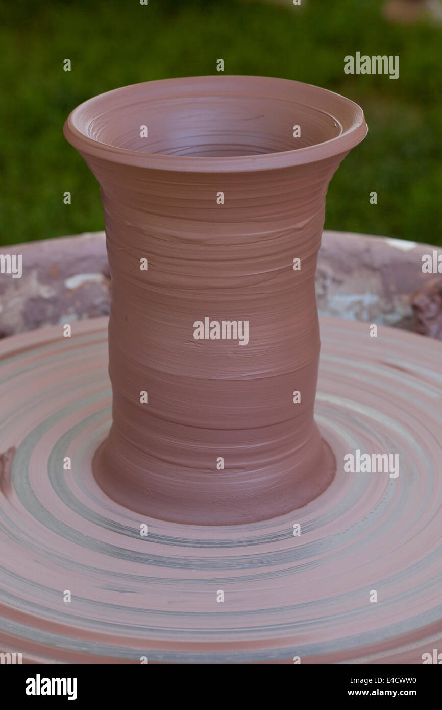 Clay vase on pottery wheel Stock Photo