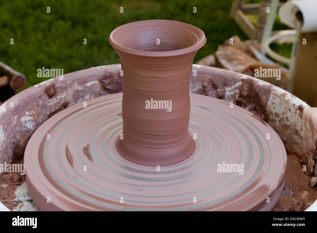 Clay vase on pottery wheel Stock Photo