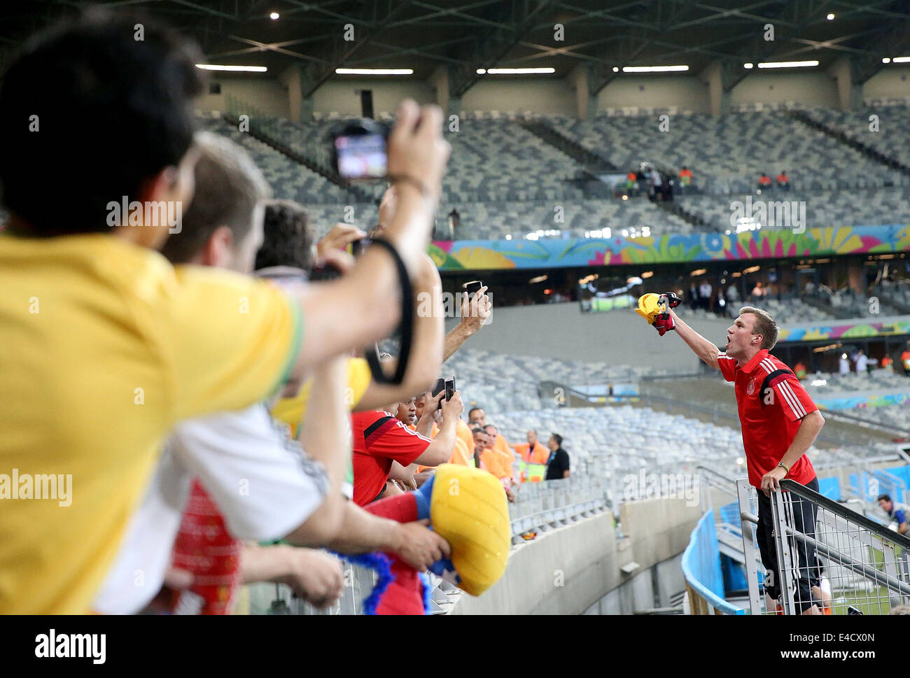 Belo Horizonte, Brazil. 8th July, 2014. Germany's Kevin Grosskreutz (R) celebrates the victory with fans after a semifinal match between Brazil and Germany of 2014 FIFA World Cup at the Estadio Mineirao Stadium in Belo Horizonte, Brazil, on July 8, 2014. Germany won 7-1 over Brazil and qualified for the final on Tuesday. Credit:  Li Ming/Xinhua/Alamy Live News Stock Photo