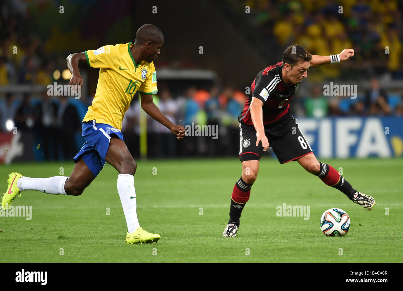 Belo Horizonte, Brazil. 8th July, 2014. Brazil's Ramires vies with Germany's Mesut Ozil during a semifinal match between Brazil and Germany of 2014 FIFA World Cup at the Estadio Mineirao Stadium in Belo Horizonte, Brazil, on July 8, 2014. Germany won 7-1 over Brazil and qualified for the final on Tuesday. Credit:  Li Ga/Xinhua/Alamy Live News Stock Photo
