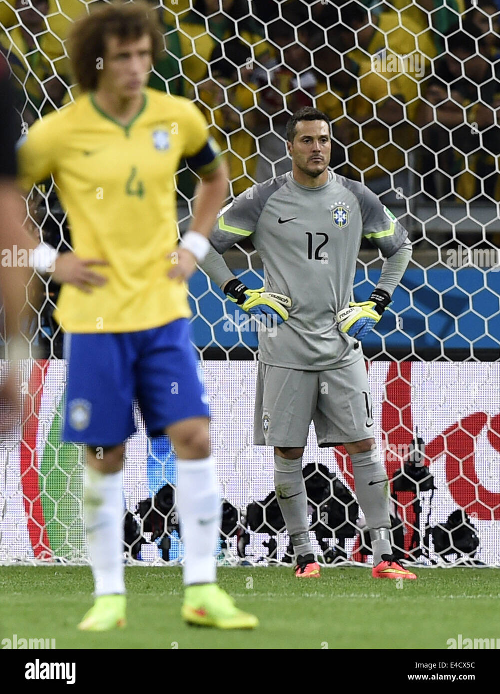 Belo Horizonte, Brazil. 8th July, 2014. Brazil's goalkeeper Julio Cesar (R) reacts during a semifinal match between Brazil and Germany of 2014 FIFA World Cup at the Estadio Mineirao Stadium in Belo Horizonte, Brazil, on July 8, 2014. Germany won 7-1 over Brazil and qualified for the final on Tuesday. Credit:  Qi Heng/Xinhua/Alamy Live News Stock Photo