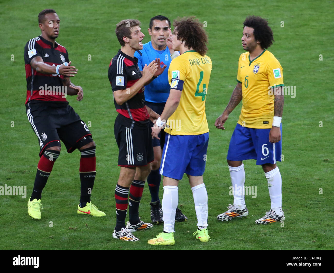 Belo Horizonte, Brazil. 8th July, 2014. Mexico's referee Marco Rodriguez (C) interrupts an arguement between Brazil's David Luiz (2nd R) and Germany's Thomas Muller (2nd L) during a semifinal match between Brazil and Germany of 2014 FIFA World Cup at the Estadio Mineirao Stadium in Belo Horizonte, Brazil, on July 8, 2014. Germany won 7-1 over Brazil and qualified for the final on Tuesday. Credit:  Li Ming/Xinhua/Alamy Live News Stock Photo