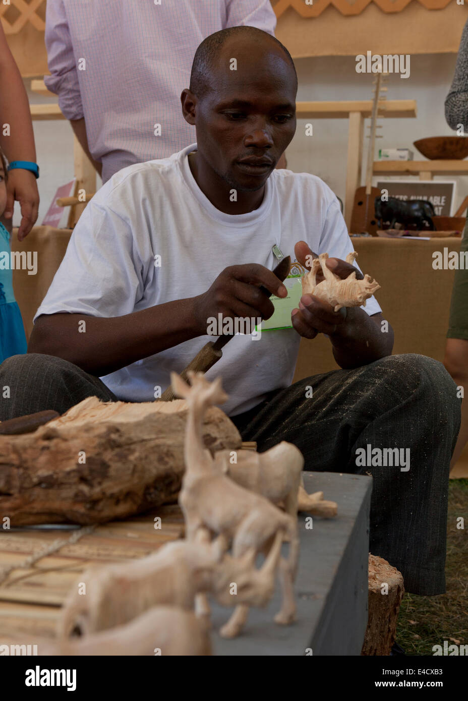 Kenyan man making animal wood carving - USA Stock Photo