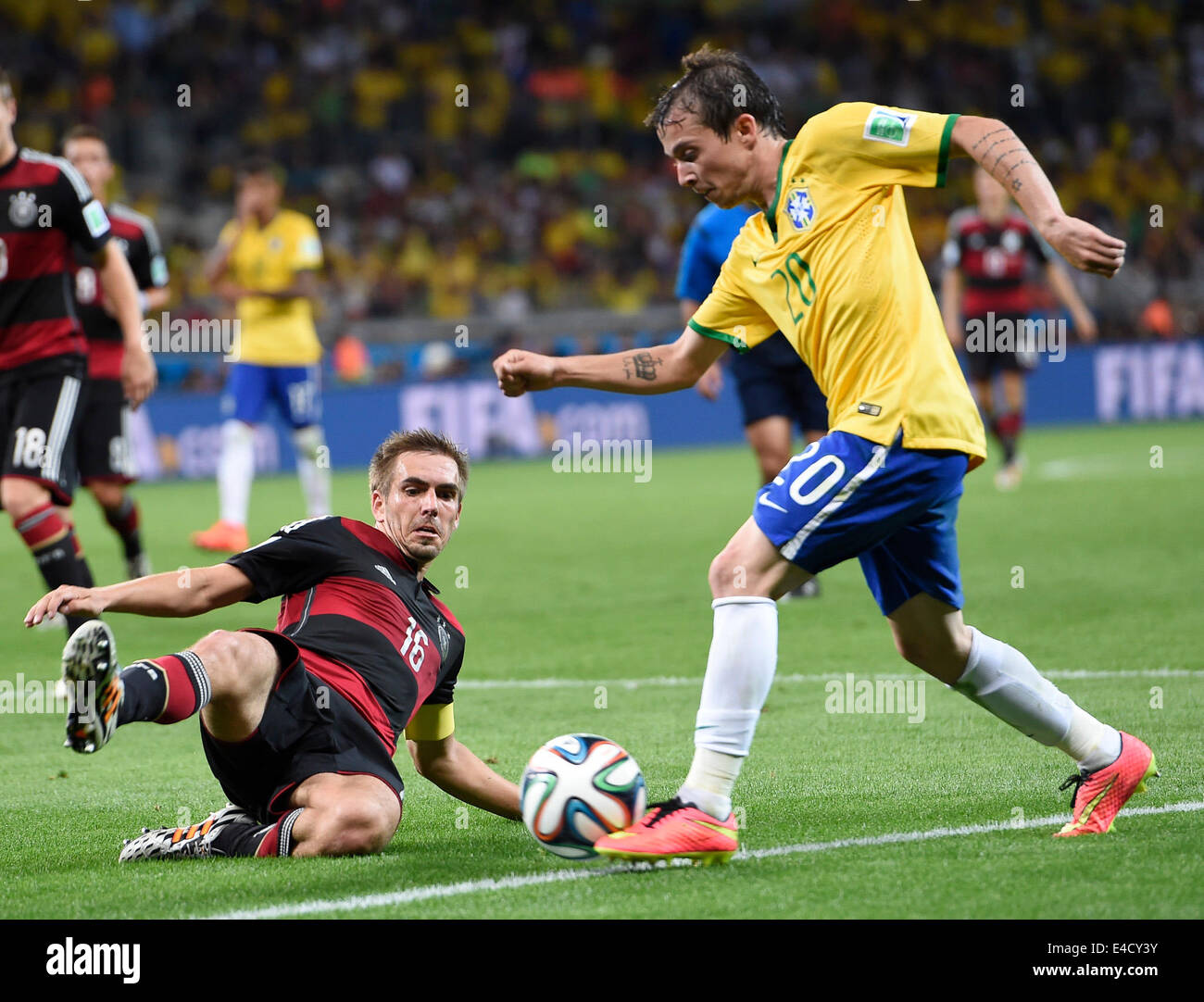 Belo Horizonte, Brazil. 8th July, 2014. Brazil's Bernard vies with Germany's Philipp Lahm during a semifinal match between Brazil and Germany of 2014 FIFA World Cup at the Estadio Mineirao Stadium in Belo Horizonte, Brazil, on July 8, 2014. Germany won 7-1 over Brazil and qualified for the final on Tuesday. Credit:  Qi Heng/Xinhua/Alamy Live News Stock Photo