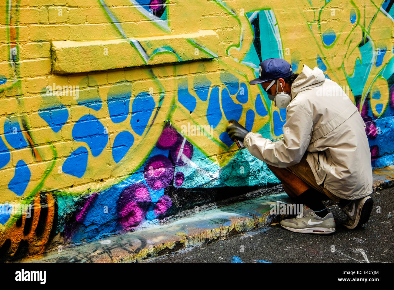 Graffiti artist at work in Melbourne laneway Stock Photo