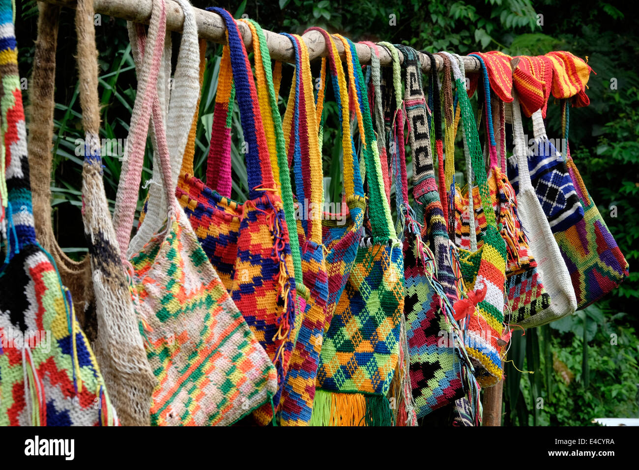 A selection of colourful hand made bags called bilums on display in Papua New Guinea Stock Photo