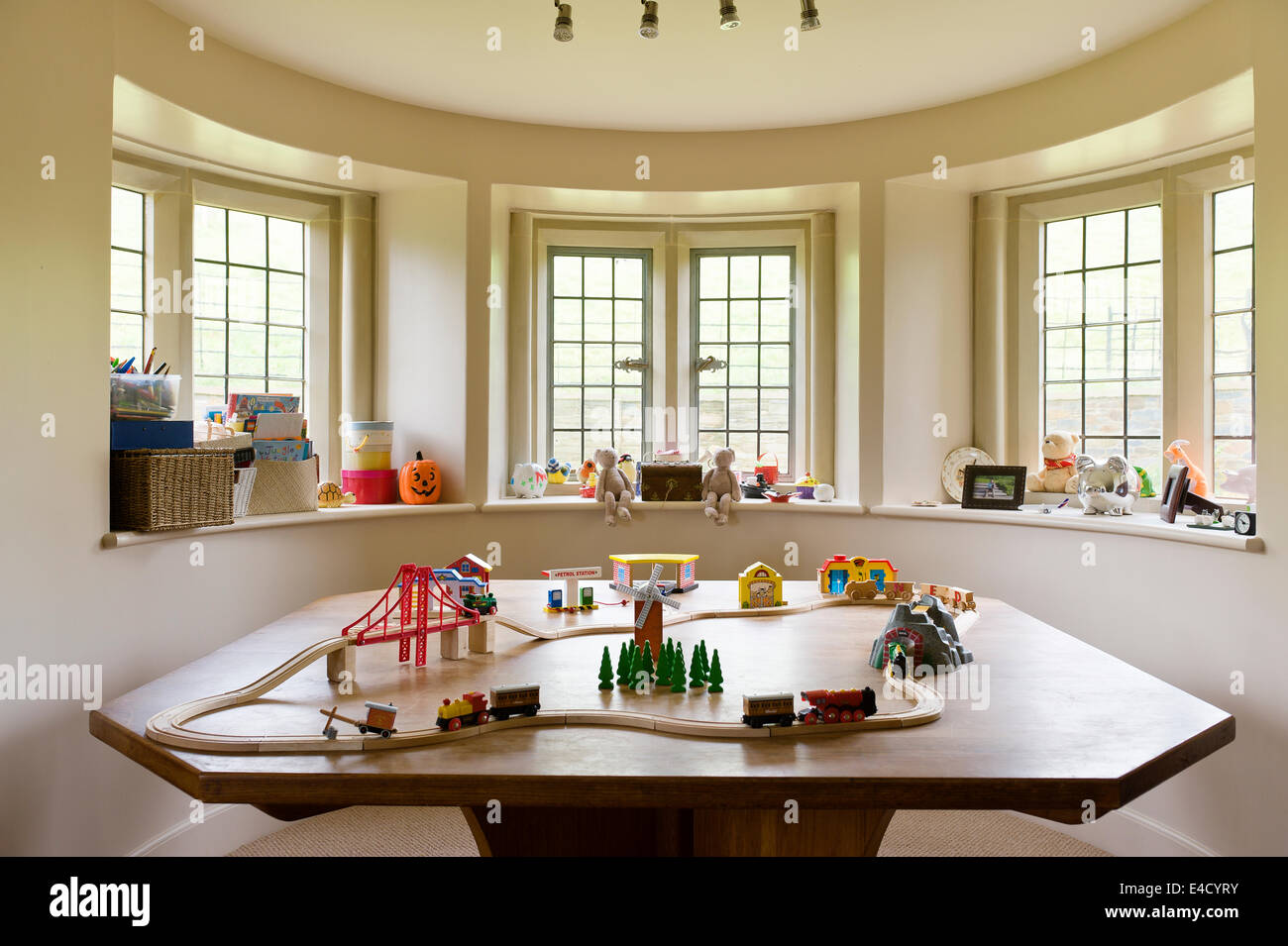 Toy train set on a large table in a children play room Stock Photo