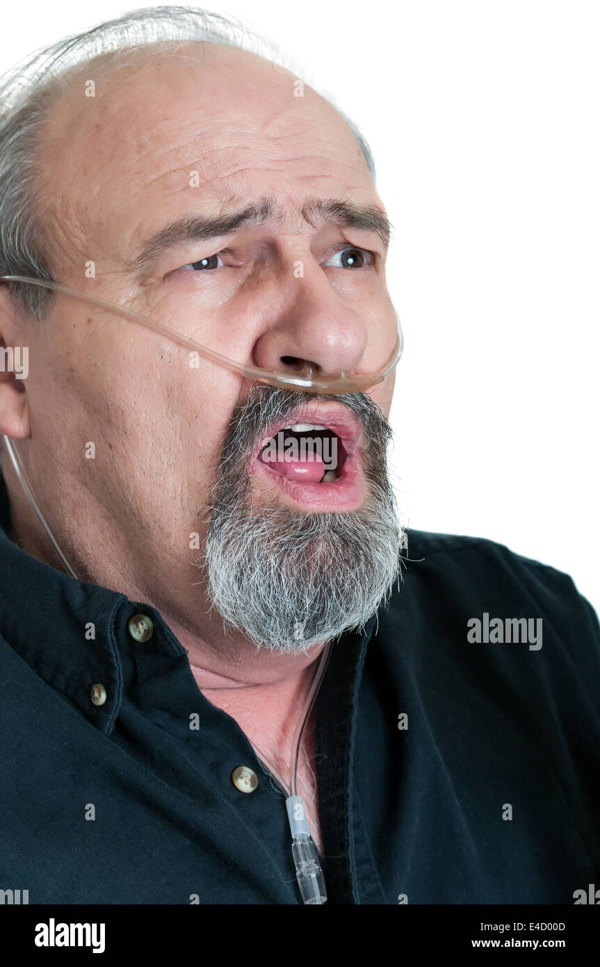 Senior male in his sixties wearing a canula to provide supplementary O2 for a breathing disorder. Stock Photo