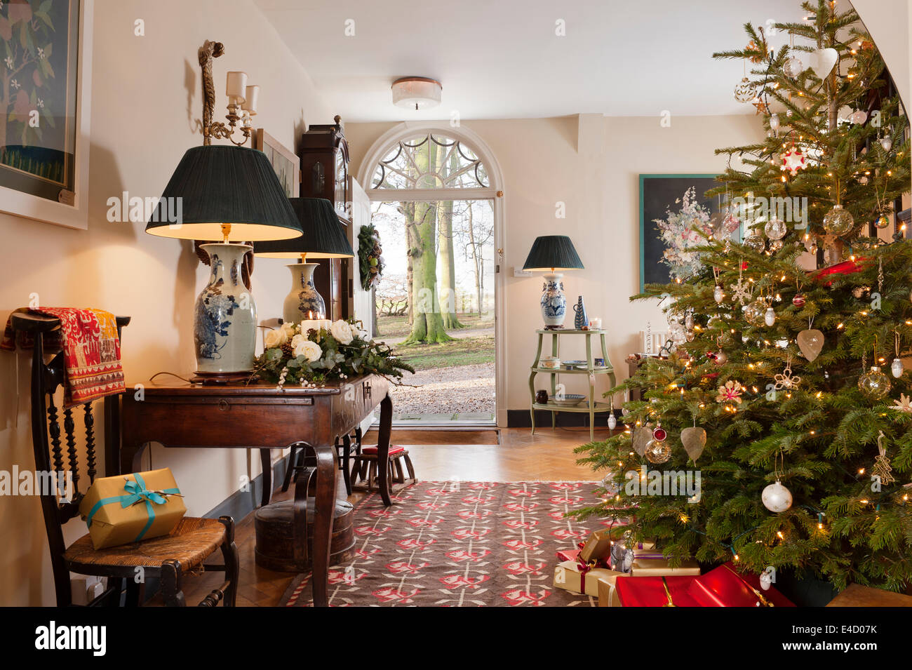 Christmas tree in entrance hall with early 20th century kilim. The hall table is French chestnut